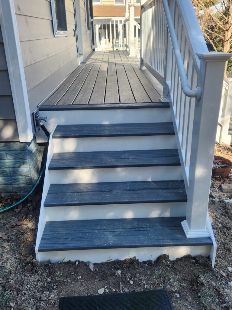 Gray and white side steps on synthetic wood deck.