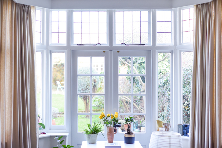 Stylish room interior with French doors and light neutral colors in a modern home