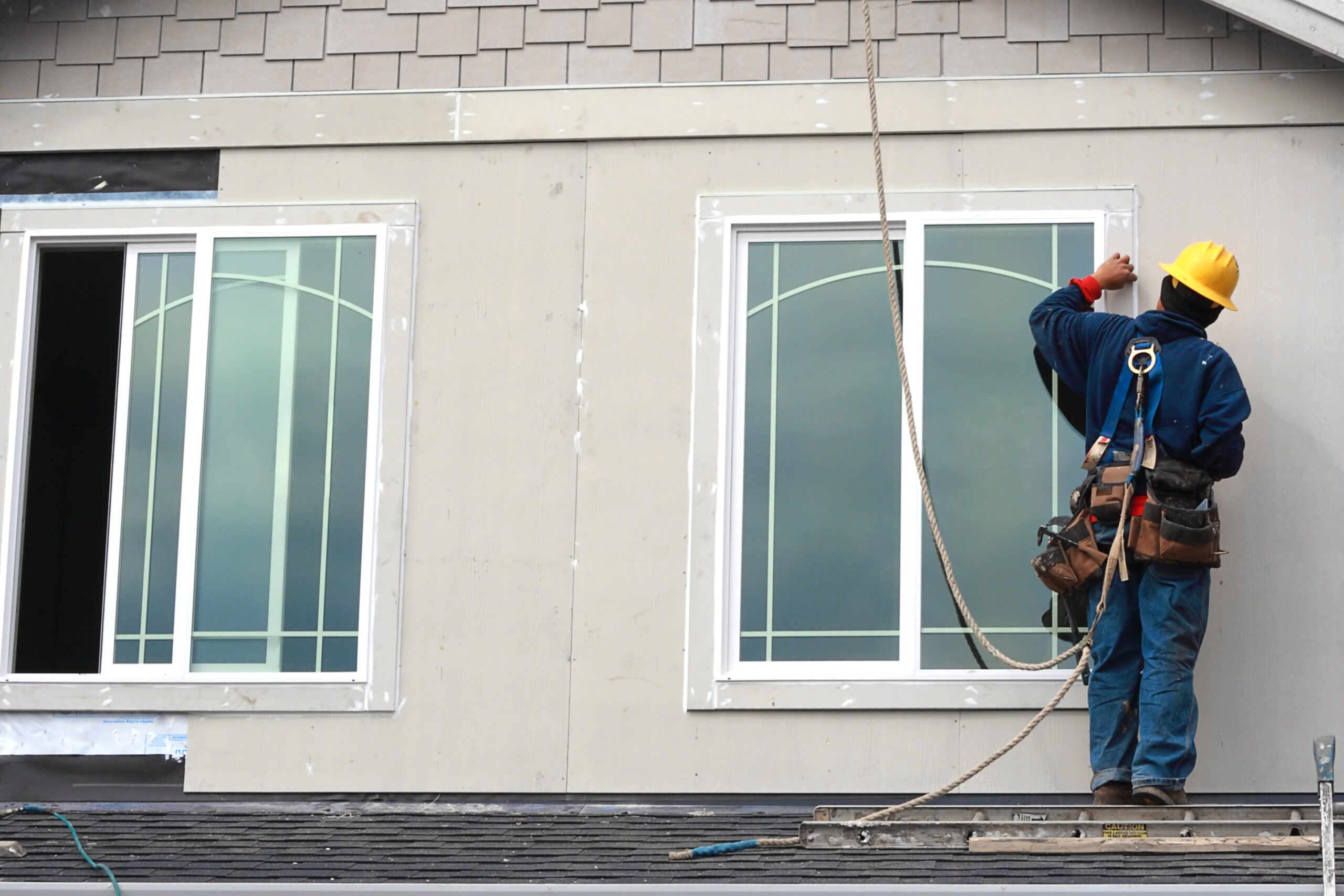 worker on roof installing new windows